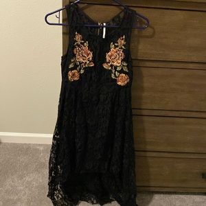 Free People high low black dress with embroidered flowers on front and back.